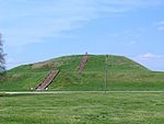 A large earthen mound with steps leading to the top