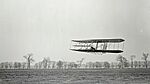  A historic photograph depicting one of the early flights of Wright brothers