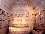 Interior of a tomb with stone reliefs representing female figures