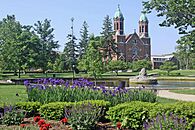 Photo of flowers, fountain, and the Chapel Building of Saint Joseph's College Summer 2011