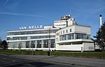 White factory building with large letters "Van Nelle"