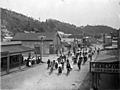 Cyclists in a Greymouth street, passing the premises of Mrs S Beresford, dressmaker, between 1898 and 1905 (4641058720)