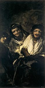 Two women laughing at a man