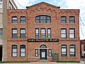A large brick building with a sign that says Ford Piquette Plant