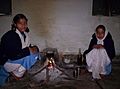 Indian girls making tea over open fire