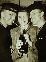 Ingrid Bergman with servicemen drinking soda during WWII (23221556673)