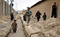 USAF 1st Lt. Raymond Gobberg, Provincial Reconstruction Team Zabul with local Afghan children during a survey of a street drainage project in Qalat