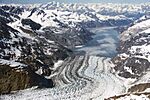 A glacier entering the sea in a mountain valley