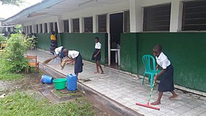 Children cleaning their classrooms