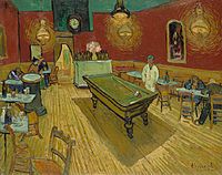 A billiard table in the centre of a room of a café surrounded by tables. Patrons are seated at several tables, and a man dressed in white stands behind the billiard table.
