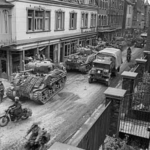 Sherman tanks and transport of 8th Armoured Brigade moving through Kevelaer, Germany, 4 March 1945. B15147