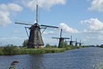 Several windmills, water channel in front