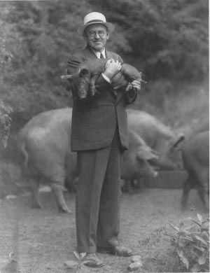 Ralph Flanders holding a piglet