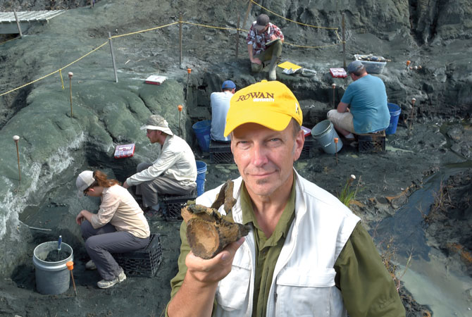 Dr. Kenneth Lacovara holding a Mosasaur vertebrae