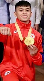 Carlos Yulo wearing a gold medal in red jacket