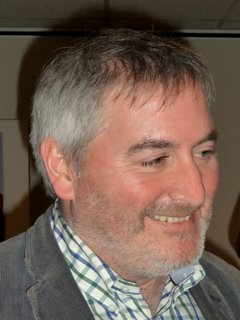 A photograph of Chris Riddell's face, smiling