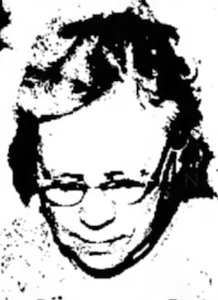 A black-and-white photo of an older woman wearing glasses, eyes cast down at her beadwork