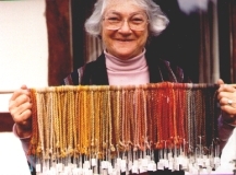 Miriam C. Rice holds mushroom dyed yarns showing full spectrum of color