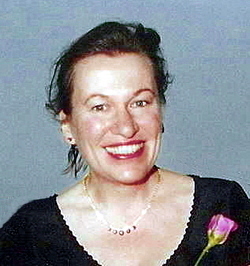 Siobhan Dowd, a female author born in the United Kingdom to Irish parents. This photograph, which shows the author with her hair up while smiling, was taken at her marriage to Geoff Morgan in March 2001, which occurred in Wales.