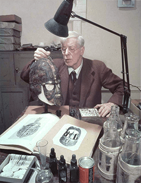 Herbert James Maryon with first reconstruction of the Sutton Hoo helmet.png