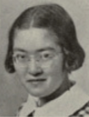 A yearbook photograph of a young Japanese woman with jaw-length hair, wearing eyeglasses