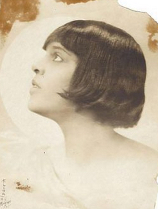 Profile of a young African-American woman. She has straight dark bobbed hair with bangs.