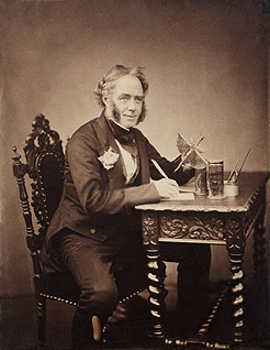 Portrait of Westwood sitting at a writing table