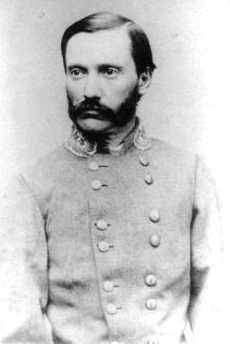 Black and white photograph of man with short hair, a mustache with connected sideburns wearing a gray uniform