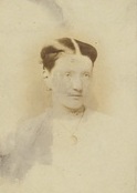 A photograph of Margaret Macpherson Grant, wearing a white shirt and a necklace