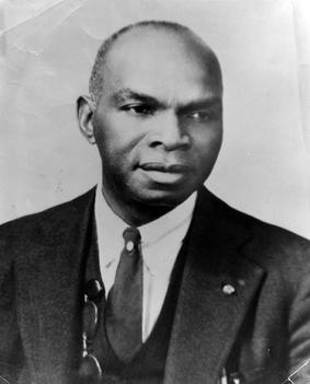 Head and shoulders of African American businessman Edward W. Pearson, Sr., wearing suit and tie