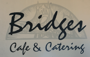The text "Bridges Cafe & Catering" with the faint illustration of a bridge in the background