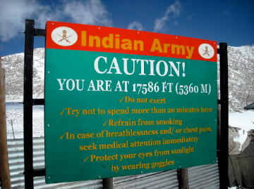 Sign displays "Caution! You are at 17586 ft (5360 m)"