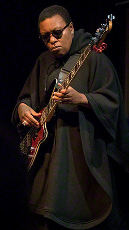 Ndegeocello playing a bass guitar onstage