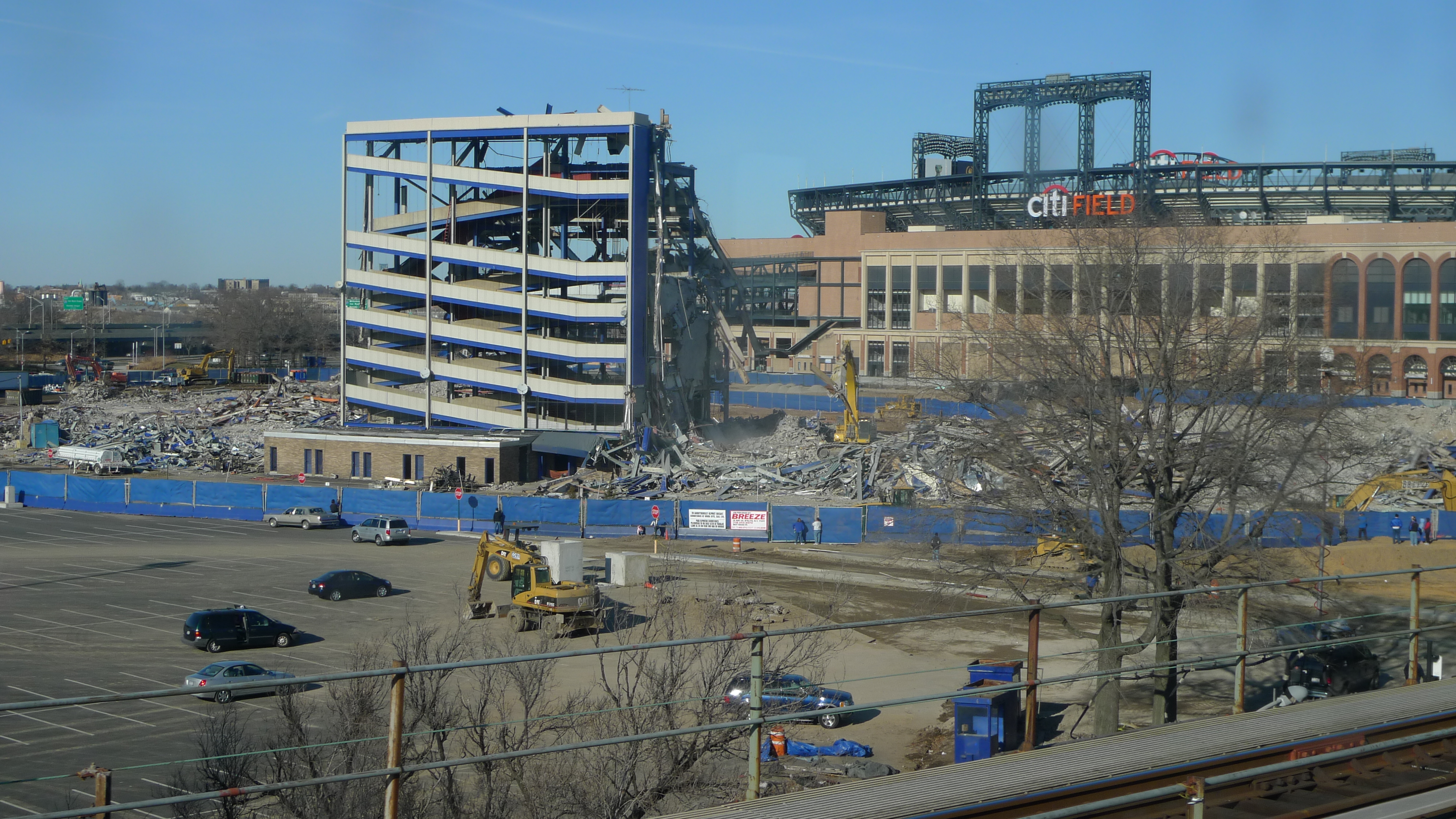Demolition viewed from the train line, with Citi Field in the background.