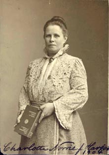 three-quarter length photo of Charlotte Norrie holding a book