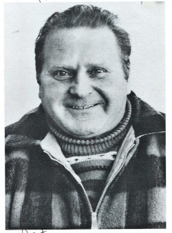 Head and shoulders portrait of Erwin Kreuz. Herr Kreuz was a brewery worker from Adelsreid, Germany; the photograph is a downscaled black-and-white halftone published during his famous trip to the United States; he is shown wearing a heavy sweater and a partially-zipped plaid jacket.