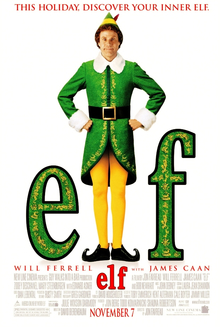 A man dressed as an elf stands between the letters "e" and "f".