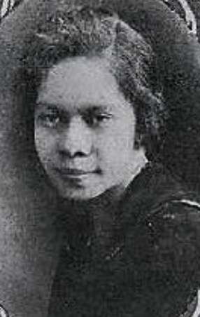 A young Black woman wearing a dark top, in an oval frame