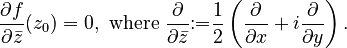 \frac{\partial f}{\partial\bar{z}}(z_0) = 0,\ \text{where } \frac\partial{\partial\bar{z}} \mathrel{:=} \frac12\left(\frac\partial{\partial x} + i\frac\partial{\partial y}\right).