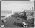 A 1993 're-photograph' of the 1917 context view (WA-203-A-1) looking east along Farragut Avenue. Building 78 is the brick building on right. Building 59 (Pattern Shop) is the HABS WASH,18-BREM,2A-2