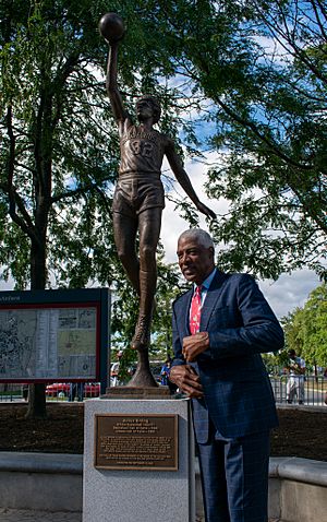 Erving standing next to his statue at UMass unveiling ceremony, Sep 10 2021