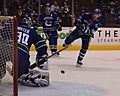 Henrik Sedin shoots Ryan Miller