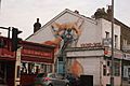 View of fox street art on the side of the New Dragon Inn Chinese takeaway on Hoe Street
