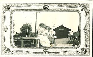 Women sitting at the train depot in Donnellson, Iowa, 1910s