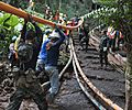 4547274 Thai rescue workers positioning a pipe for the pumping operation in the Tham Luang cave
