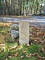 Granite Monument on Maple Road pointing to the John Kettell Monument on Stiles Farm Road in Stow Massachusetts MA USA one fo the first two settlers of Stow lived here and was killed by the Indians 1676