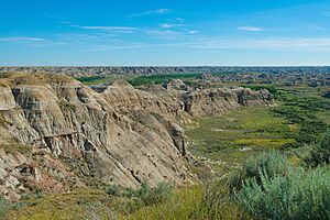 Rock formations in Dinosaur Provincial Park near an Albertan river - July 2014.jpg