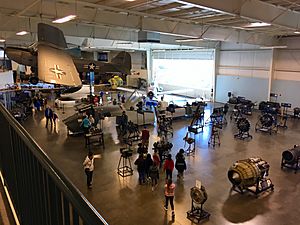 Visitors inside the Exhibit Hall at the Aerospace Museum of California near the Engine Exhibit