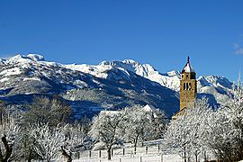 A view of the church and the surrounding mountains in winter