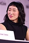 Closeup photo of Ji-young Yoo at a panel. She is looking off to her right, not directly toward the camera.